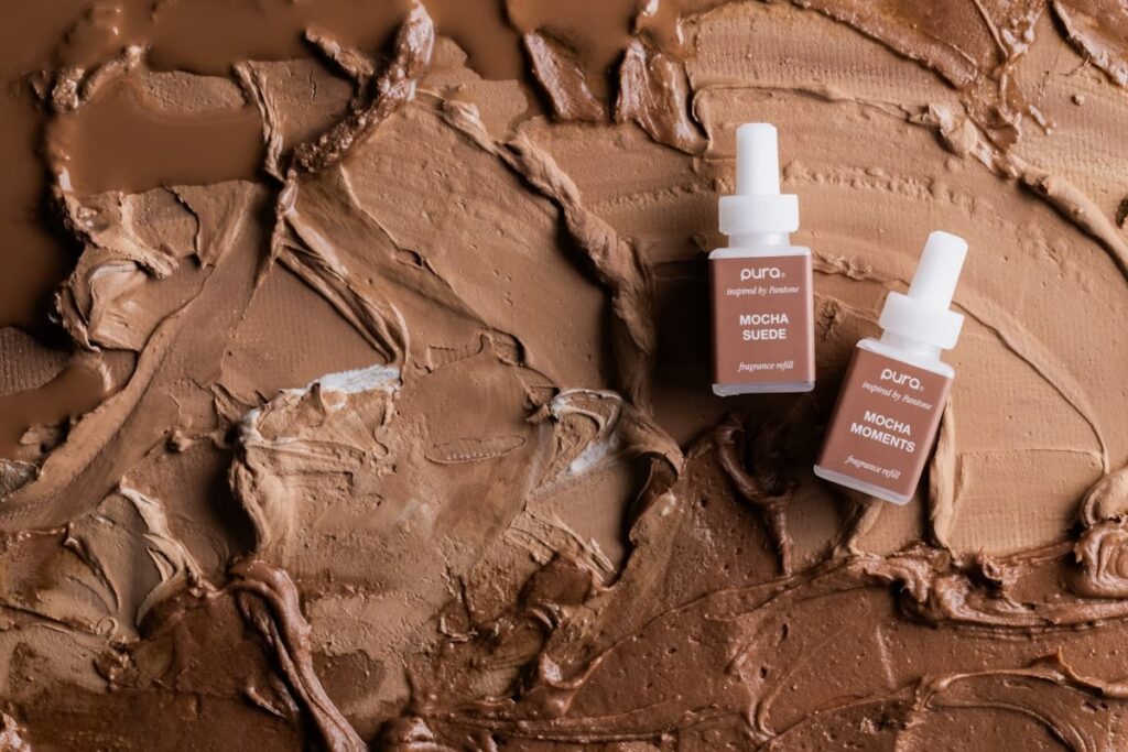 Pura Mocha Suede and Mocha Moments fragrance refills on Pantone Mocha Mousse textured background
