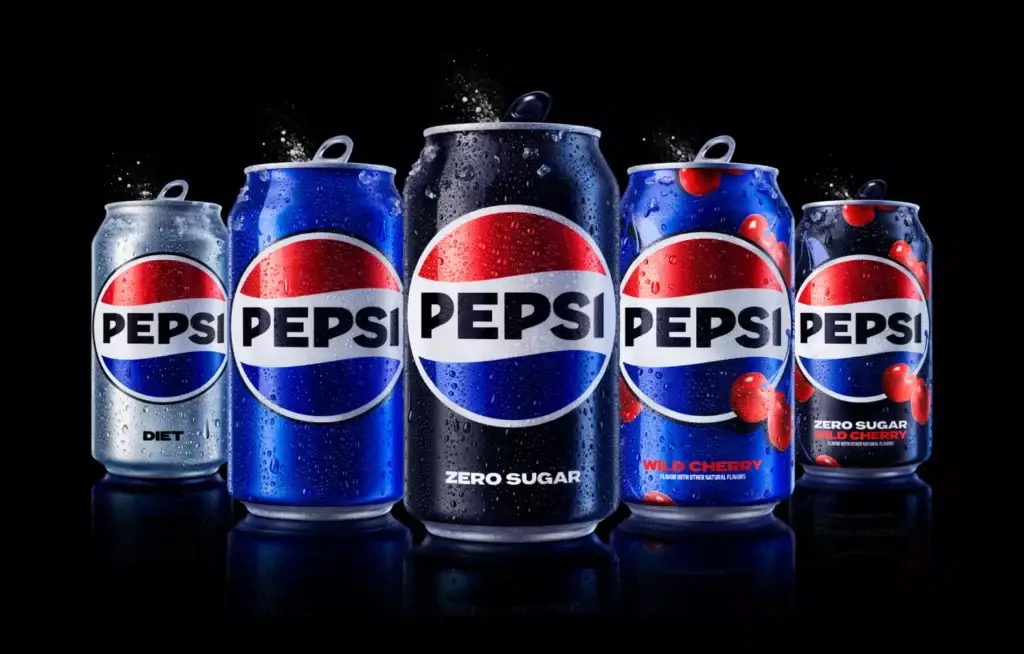 Lineup of Pepsi cans including Classic, Diet, Zero Sugar, Wild Cherry, and Zero Sugar Wild Cherry, with condensation against a black background.
