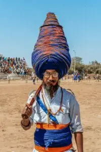 Nihang Sikh wearing a tall blue turban at Hola Mohalla festival in Punjab