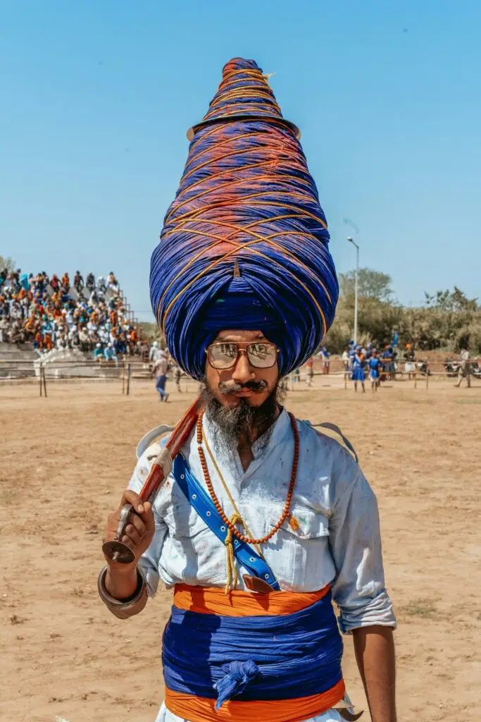 Nihang Sikh wearing a tall blue turban at Hola Mohalla festival in Punjab
