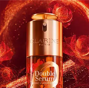 Clarins Double Serum bottle with glowing red serpentine graphics symbolising snake-inspired fluidity.