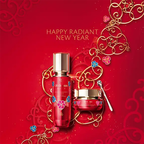 Clé de Peau skincare packaging with red and gold intertwined motifs symbolising snake-inspired design