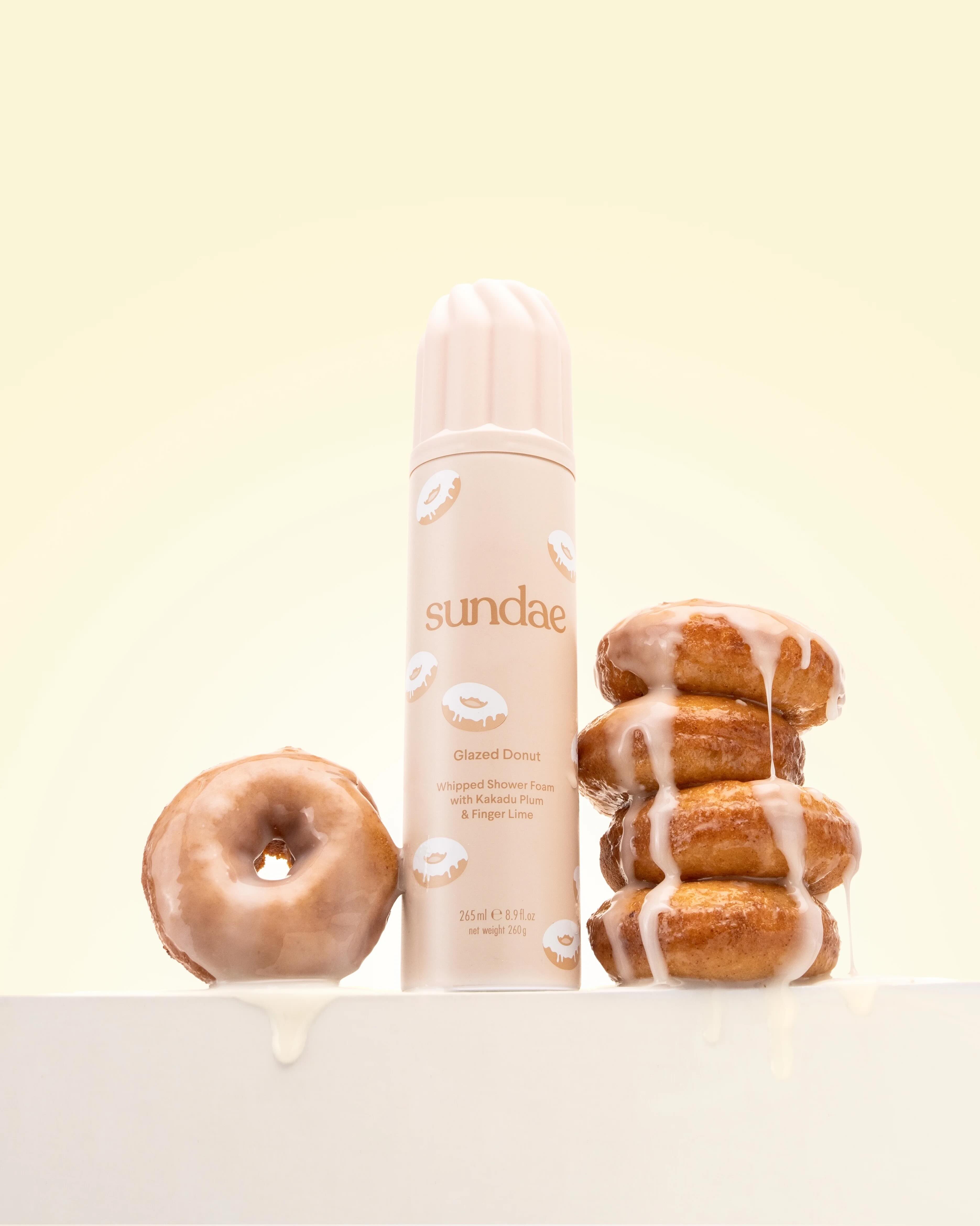 Food imagery in marketing showing shower foam styled with glazed donuts
