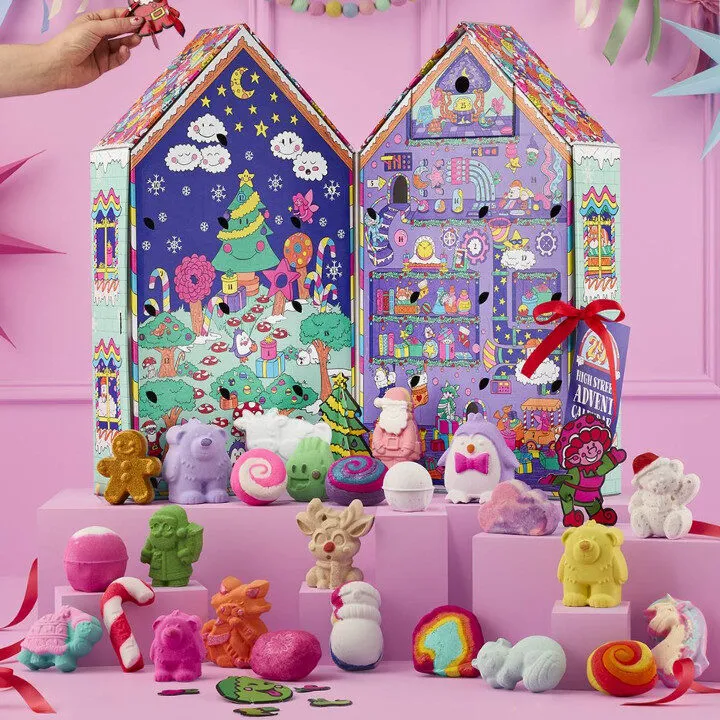 Lush colourful advent calendar with whimsical characters and candy-bright bath bombs, showing playful Christmas 2025 graphic codes.