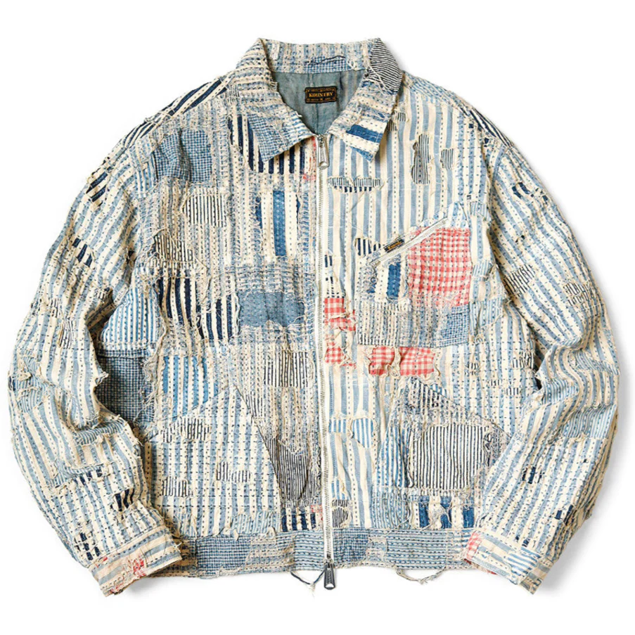 Patchwork jacket made from layered indigo fabrics inspired by Japanese Boro techniques.