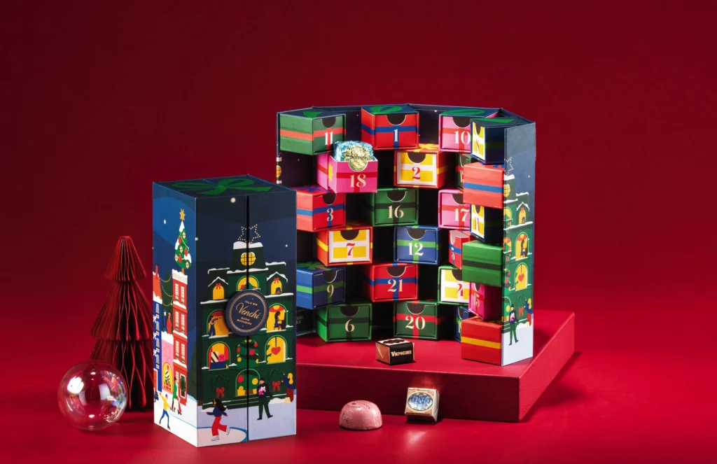 Venchi advent calendar with colourful illustrated drawers and festive city scenes, showing playful Christmas 2025 graphic codes.