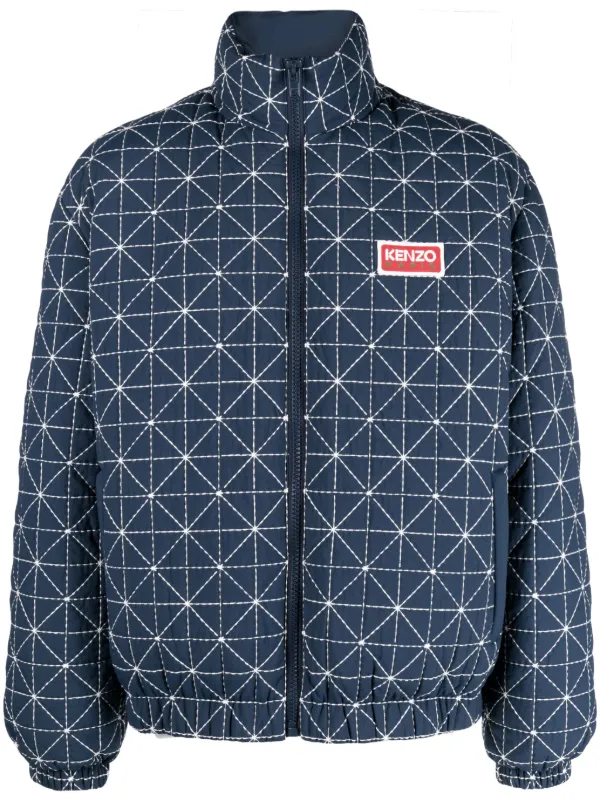 Quilted navy jacket with white geometric Sashiko stitching by a contemporary fashion brand.