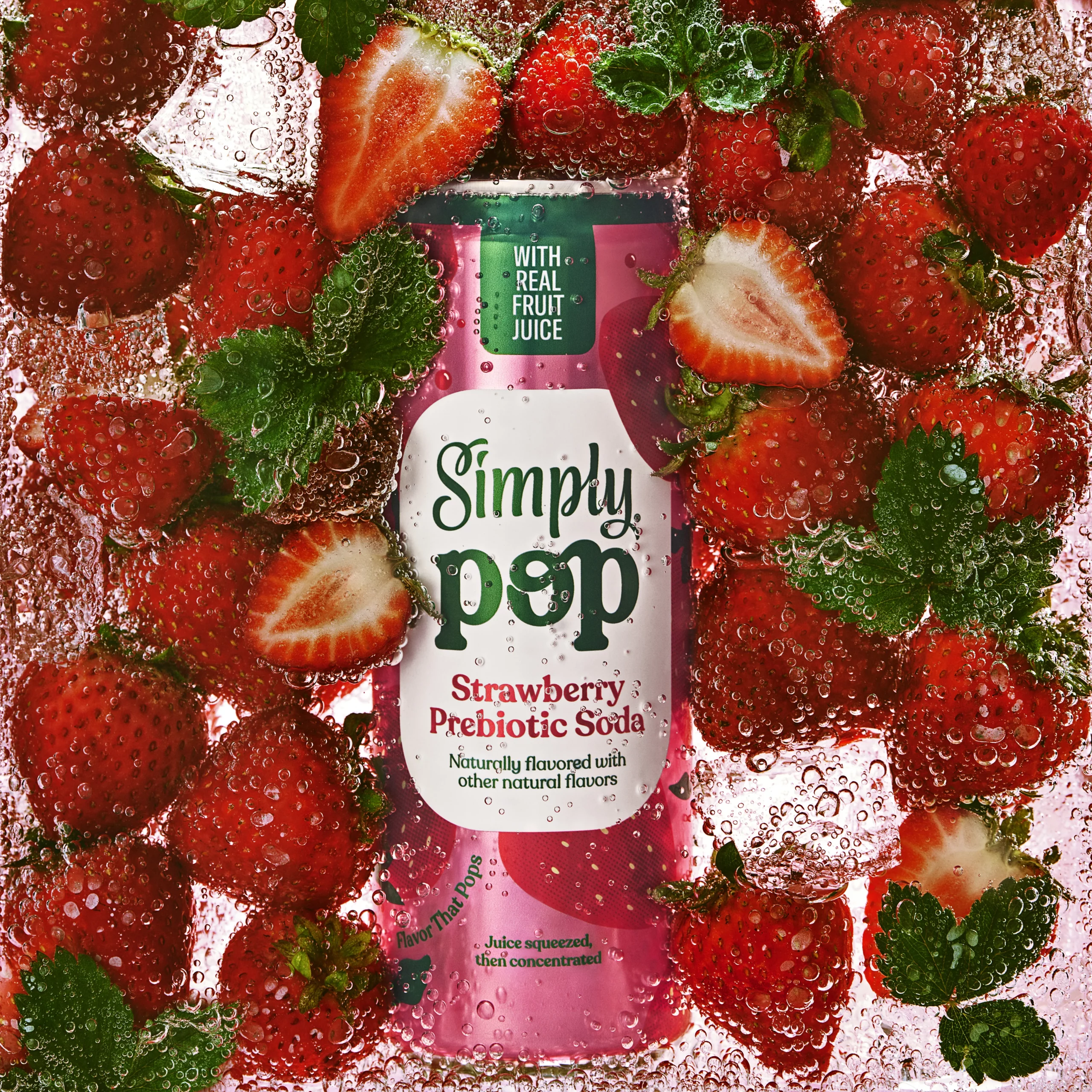 Simply Pop strawberry prebiotic soda surrounded by fresh strawberries, illustrating mainstream gut health beverage innovation.