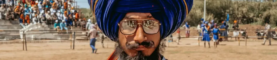 Nihang Sikh wearing a tall blue turban at Hola Mohalla festival in Punjab