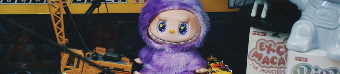 Plush toy surrounded by collectibles and toy cars, illustrating regressive nostalgia and kidult culture among adults